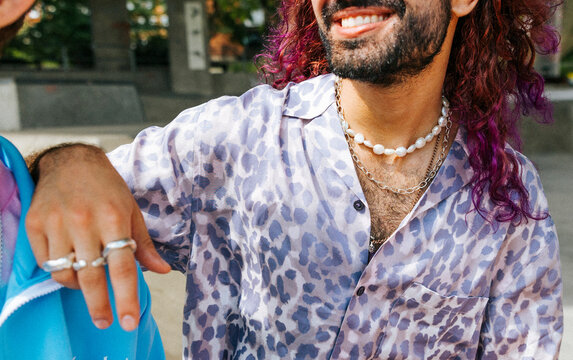 Smiling man with dyed hair wearing chains