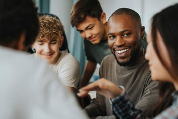 Happy male teacher looking at teenage girl discussing in classroom