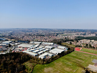 aerial view of mixed land use showing sports fields next to an industrial estate with residential housing in the background