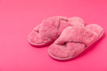 Soft slippers on a bright colored background, close-up. House slippers. Comfortable shoes for home. Foot care concept. Home comfort. Space for text. Copy space.