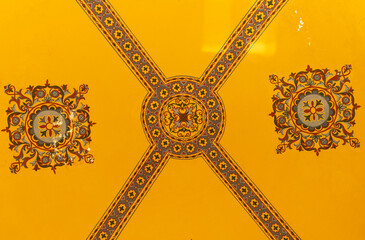 a stunning example of Byzantine art and architecture, specifically from the Hagia Sophia in Istanbul, Turkey. The ceiling is adorned with intricate mosaics, featuring geometric patterns, floral motifs