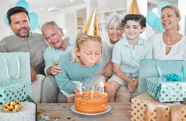 Girl, birthday cake and blow candles with family in home, cheers and excited with wish for present....