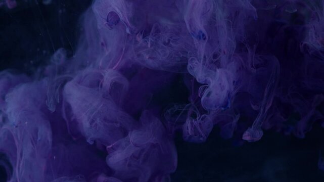 dark purple ink in water against a black background