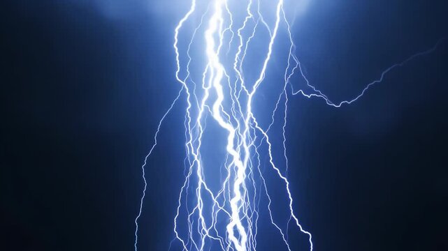 A bolt of lightning strikes the sky, illuminating the dark clouds. Concept of power and energy, as well as the unpredictability of nature