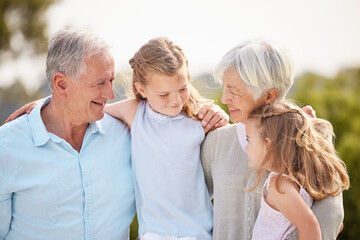 Happy, park and children with grandparents in nature for bonding, relationship and relax together on weekend. Family, hug and grandpa, grandma and girls outdoors for playing, vacation and holiday