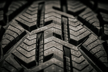 Close-up of a winter tire tread pattern, showcasing the intricate grooves and zigzag details...