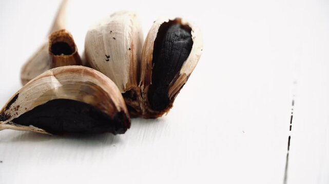 Black garlic on white background.