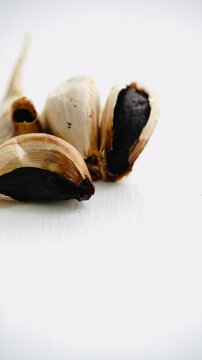 Black garlic on white background.