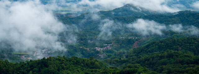 Banner Beautiful Mountain landscape foggy mountain green landscape morning sunrise. Amazing Landscape mountain green tropical forest tree on sunrise. Banner forest sunlight scenery with copy space