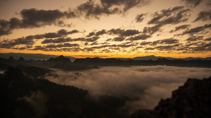 Sunset mountain range beautiful landscape mist foggy sunrise beam. Golden sky Mountain landscape foggy windy mountain. Amazing Landscape cloud sky on sunrise. Countryside gold sunlight heaven scene