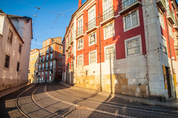 Obraz premium Charming streets in Lisbon, Portugal bathed in golden sunlight, inviting exploration of vibrant architecture and the melody of distant trams in the late afternoon