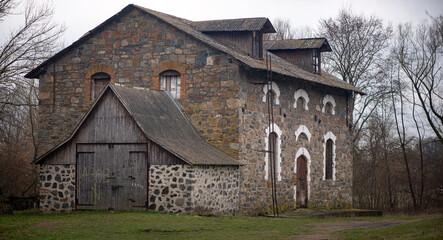 A granite mill from the time of the Tsarist Empire.In the kingdom of granite stones, a monumental mill was built.Historic mill with fall colors on the landscape. 
