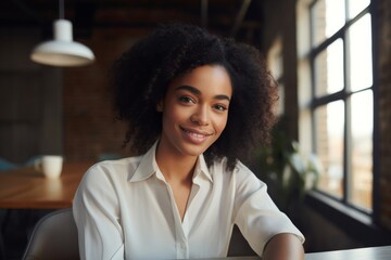 Portrait of radiant young African American businesswoman in modern office
