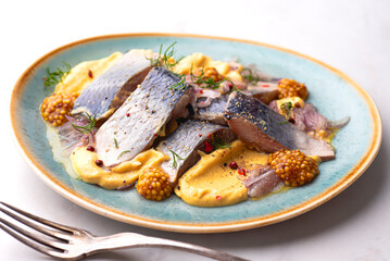 Swedish style herring with mustard dressing seasoned with a variety of peppers, sweet and salty taste, Baltic herring. Iconic Scandinavian snacks and appetizers full of omega 3 and source of protein