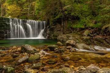Fototapeta premium forest autumn scene with waterfall in Krkonose mountains