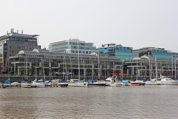 The boats standing in the harbor of Buenos Aires with skyscrapers in the background