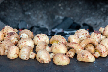 Grilled mushrooms on grill, grilling champignons 