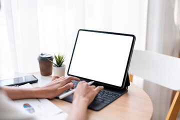 Businesswoman working from home using digital tablet with blank screen