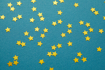 Golden glittering stars on vibrant blue background, perfect for adding a touch of luxury to your celebrations. Ideal for cards, invitations, banners, or wallpapers.