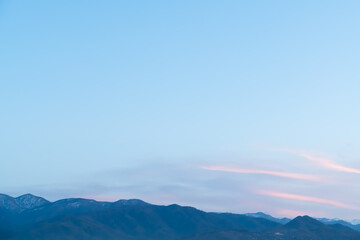 Clear skies over a rugged mountain range &ndash; serene landscape with layers of peaks and crisp winter air