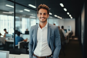 Smiling portrait of a young Caucasian businessman in modern office
