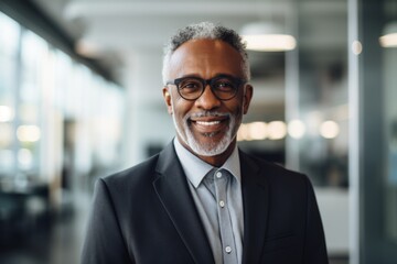 Fototapeta premium Smiling portrait of a senior African American businessman in modern office