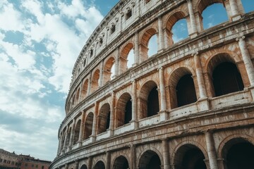 Fototapeta premium Stunning view of the majestic roman colosseum under a clear blue sky with fluffy white clouds
