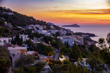 Sunset on Kalymnos, Greece. View over the village of Massouri to the sea with orange colored sky of...