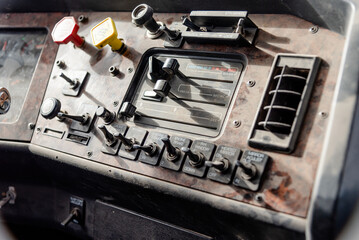 Interior View of an Old Semi Truck Dashboard: Dusty Controls for Air Brakes, Cruise Control, and...