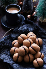 Lady's kisses, traditional Italian nut cookies with coffee and chocolate filling.