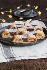 Grandfather's mustache cookies made from shortcrust pastry filled with nuts, jam and cocoa, Christmas toys and garland.