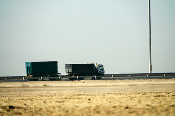 Highway in the desert, mirage. Arabian Peninsula, Different types of road transport