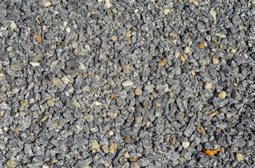 Abstract background of small stones. Gray crushed stone , scattered in an embankment. Landscape design.