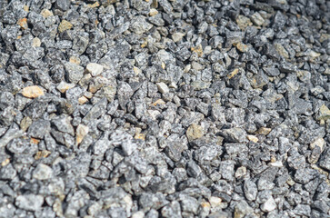 Fine gray crushed stone, textured background, full frame. Use as building material in construction.