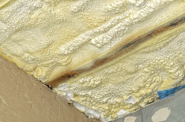 Ceiling with foam for insulation, concrete walls. Concept of building new house and reconstruction.