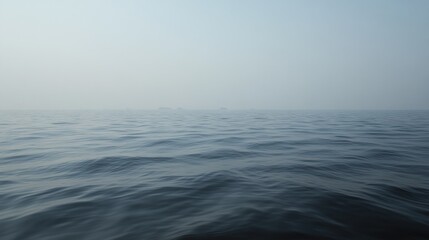 Obraz premium A hazy, calm ocean surface with subtle waves.