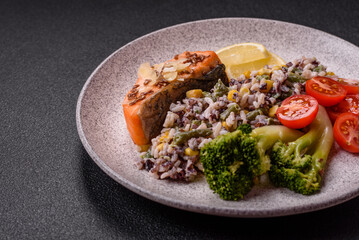 Grilled salmon with salt and spices, broccoli, tomatoes, rice