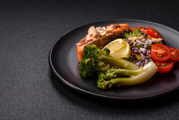 Grilled salmon with salt and spices, broccoli, tomatoes, rice