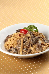 fettuccine with dried mushroom sauce on plate
