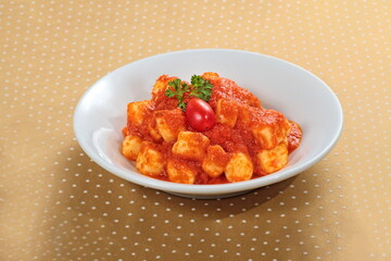 potato gnocchi in tomato sauce on a plate