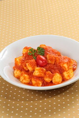 potato gnocchi in tomato sauce on a plate