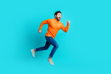 Fototapeta na wymiar Photo of cheerful funky nice man wear stylish clothes jump up run empty space isolated on cyan color background