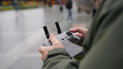 A man holds a drone remote control in his hands