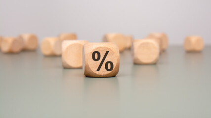 Wooden Dice Featuring a Percentage Symbol That Represents Various Finance Concepts