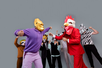 Photo of zebra raccoon lion panda sloth mask people gorilla rooster fight isolated on grey color...