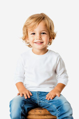 A cheerful blond boy with a bright smile poses against a white background while sitting comfortably on a stool