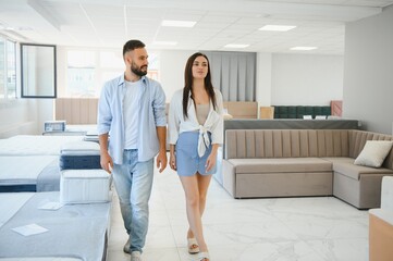 Woman with her husband at the furniture store showroom