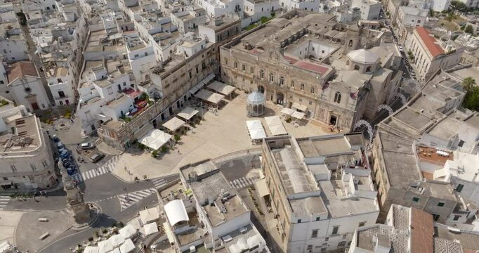 Aerial view of the church of San Francesco, the column of Sant' Oronzo and the town hall of Ostuni, in the province of Brindisi, in Puglia, Italy. They are located in the historic center of the city.