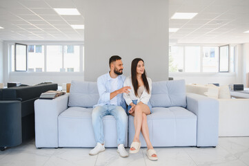 Couple chooses upholstered furniture in store