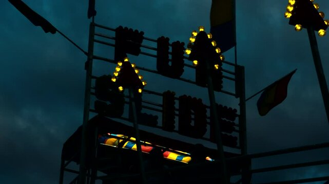 Carnival Slide at Night with Bright Lights Illumination Sky, Amusement Park Rides